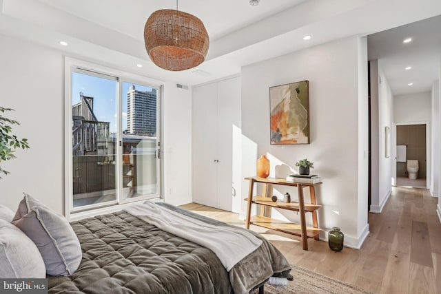 bedroom with access to outside and light wood-type flooring