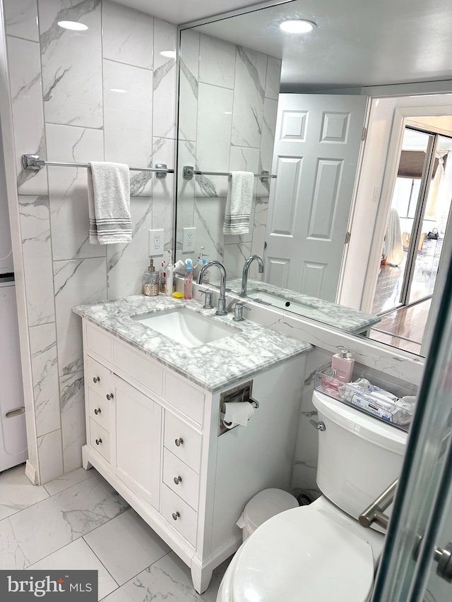 bathroom featuring toilet and vanity