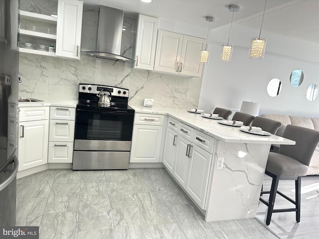 kitchen with white cabinets, electric stove, kitchen peninsula, and wall chimney exhaust hood