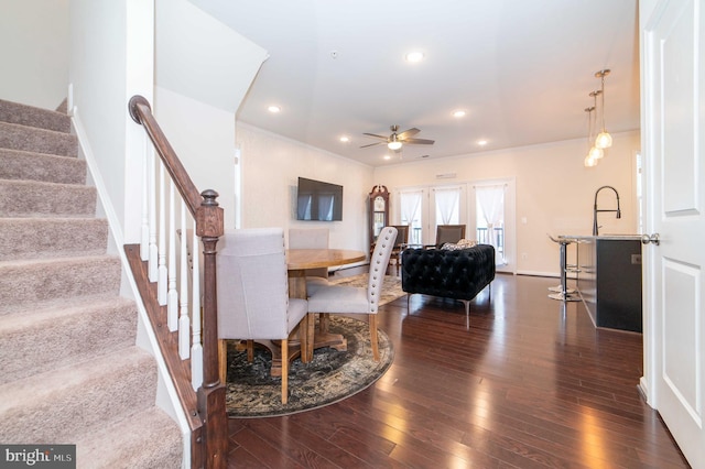 living room with dark hardwood / wood-style floors and ceiling fan