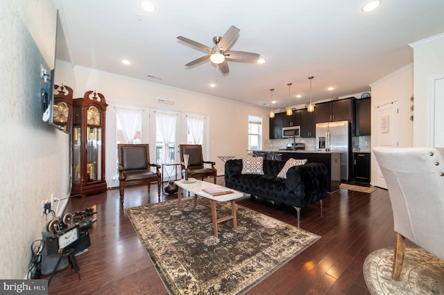 living room with ceiling fan, ornamental molding, and dark hardwood / wood-style floors