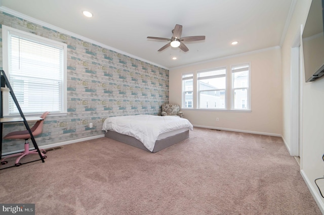 carpeted bedroom with crown molding and ceiling fan