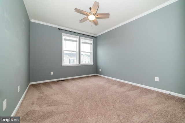 empty room with crown molding, carpet floors, and ceiling fan