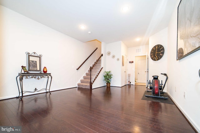 exercise room featuring dark hardwood / wood-style floors