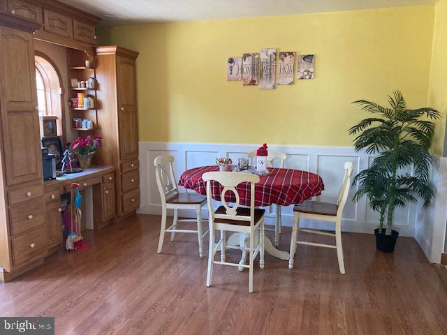 dining space with hardwood / wood-style floors