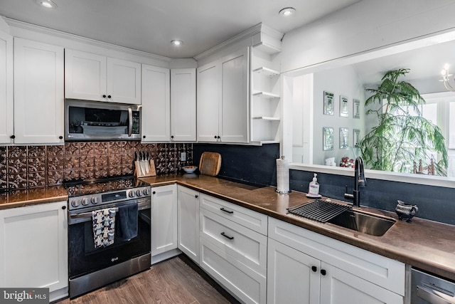 kitchen featuring tasteful backsplash, appliances with stainless steel finishes, sink, and white cabinetry