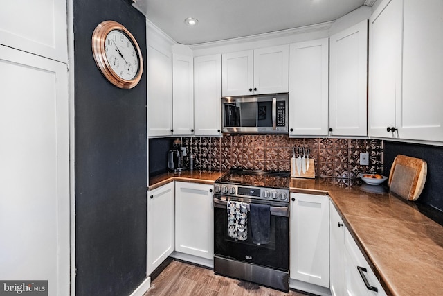 kitchen with appliances with stainless steel finishes, decorative backsplash, and white cabinetry