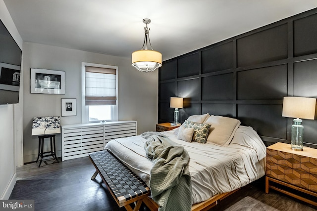 bedroom with dark hardwood / wood-style flooring