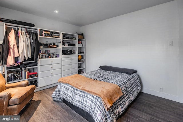 bedroom with dark hardwood / wood-style floors