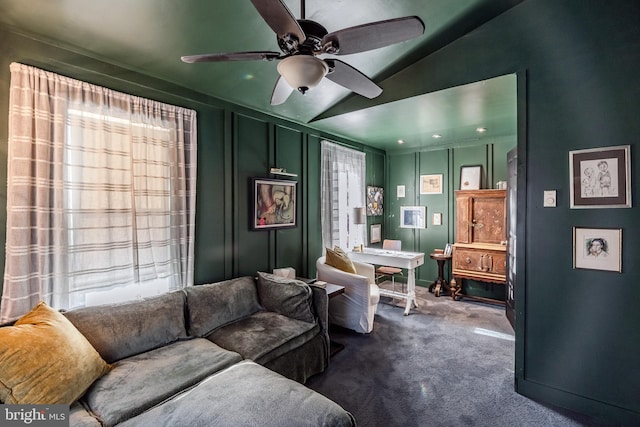 living room with ceiling fan, carpet, and lofted ceiling