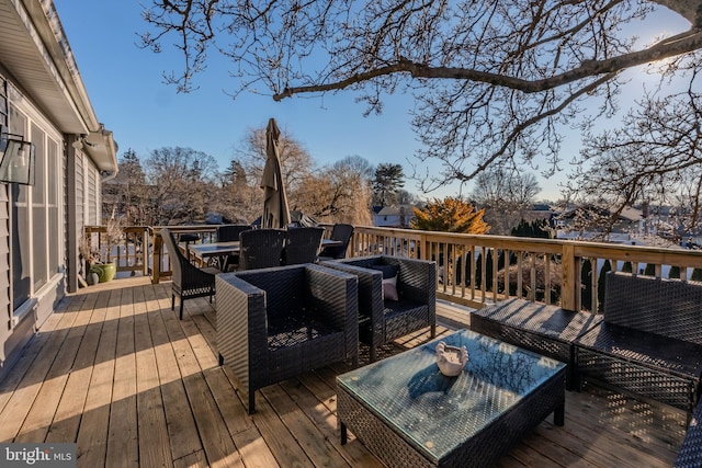 wooden terrace with an outdoor hangout area