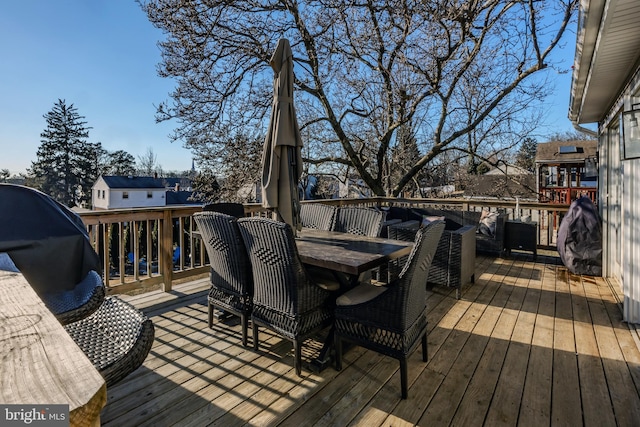 wooden deck with a grill