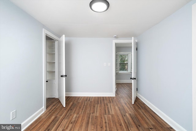 unfurnished bedroom featuring dark hardwood / wood-style floors