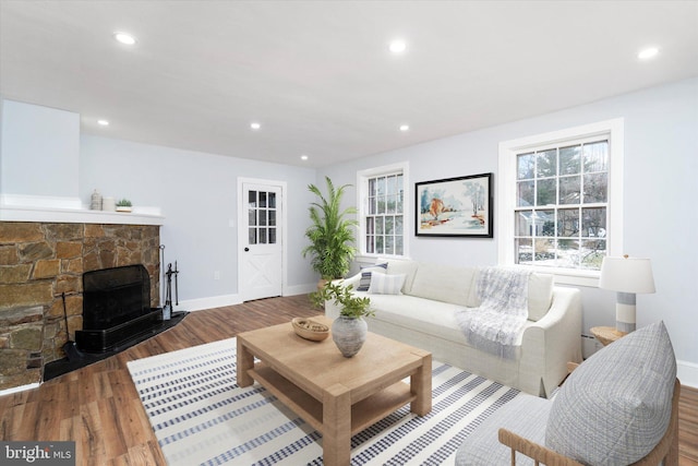 living room with a fireplace and dark wood-type flooring