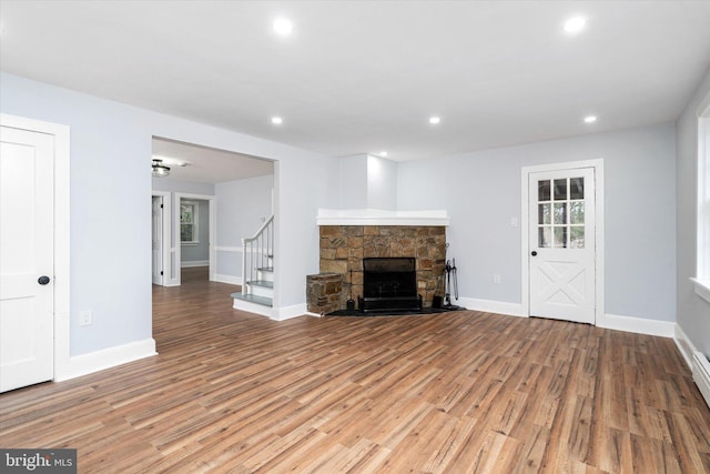 unfurnished living room with a fireplace and wood-type flooring