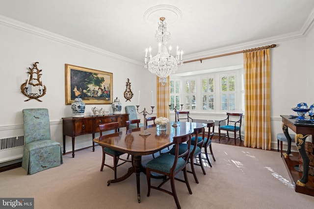 carpeted dining space with crown molding and a chandelier