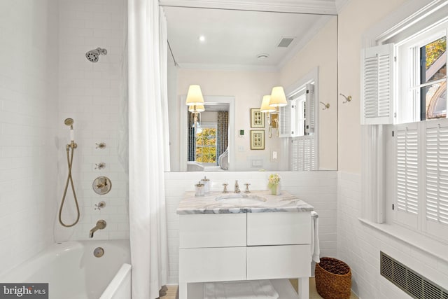 bathroom featuring vanity, tile walls, ornamental molding, and shower / bathtub combination with curtain