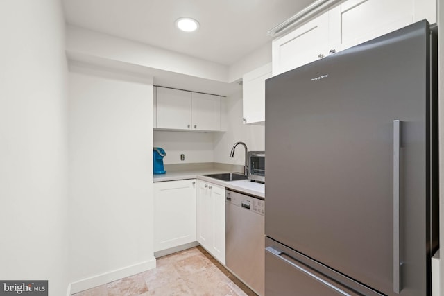 kitchen featuring sink, white cabinets, and appliances with stainless steel finishes