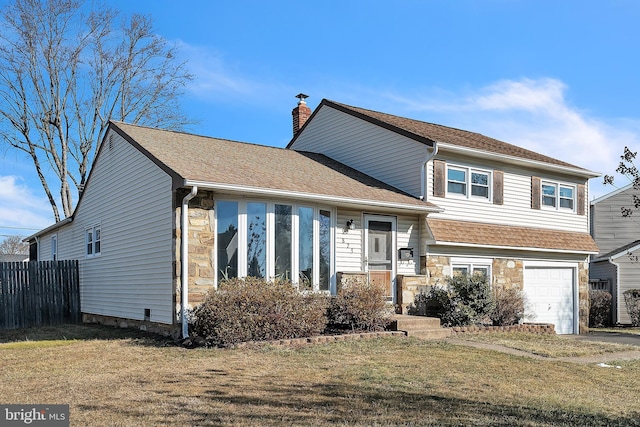 split level home with a front yard and a garage