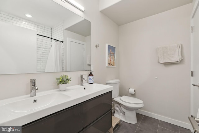 full bath featuring tile patterned flooring, baseboards, a sink, and toilet