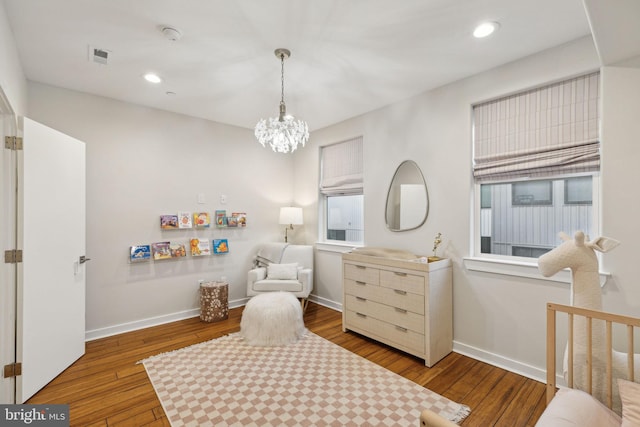 sitting room featuring recessed lighting, wood-type flooring, a notable chandelier, and baseboards