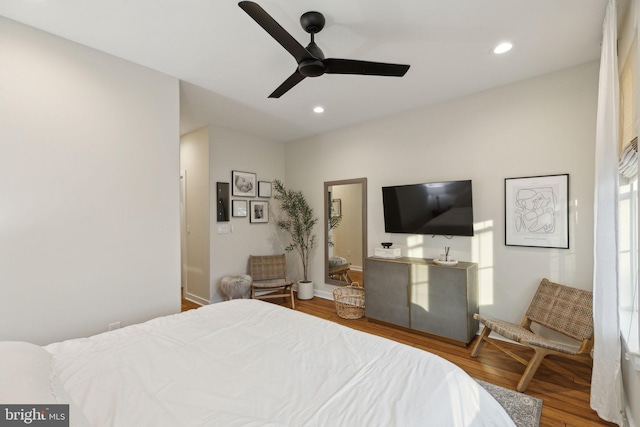 bedroom with ceiling fan, wood finished floors, and recessed lighting