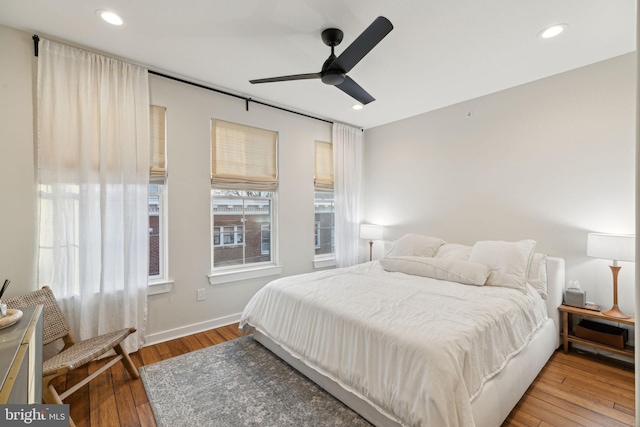 bedroom with baseboards, a ceiling fan, hardwood / wood-style flooring, and recessed lighting