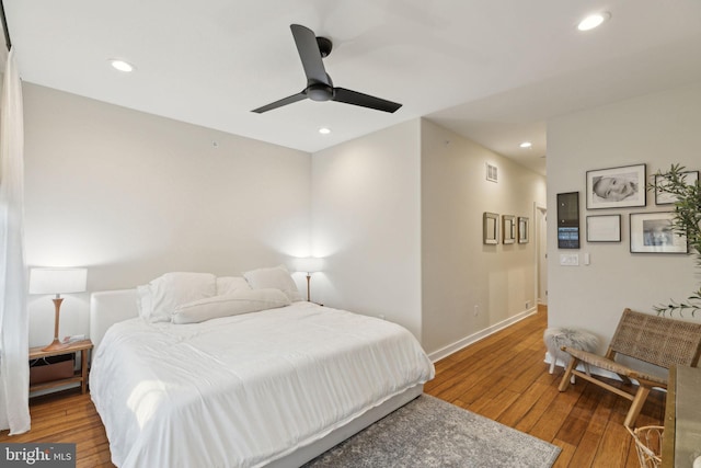 bedroom featuring a ceiling fan, baseboards, hardwood / wood-style floors, and recessed lighting