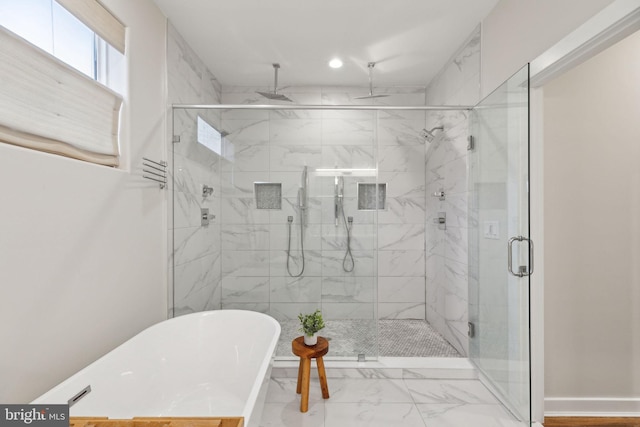 bathroom with recessed lighting, baseboards, marble finish floor, a soaking tub, and a stall shower