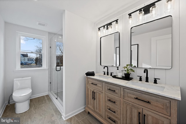 bathroom with walk in shower, vanity, and toilet