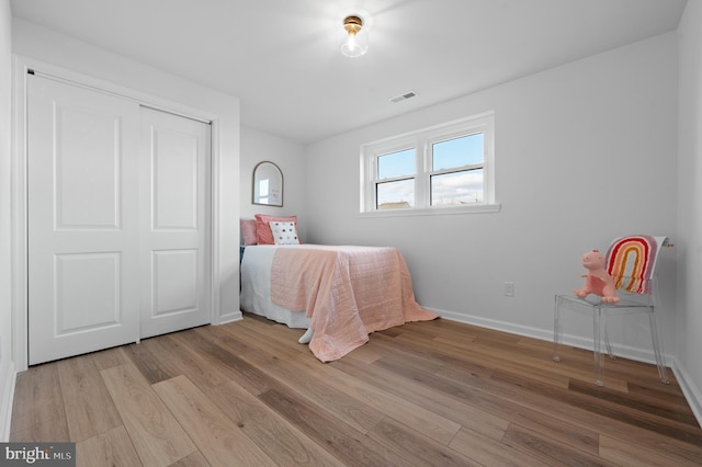 unfurnished bedroom with light wood-type flooring and a closet