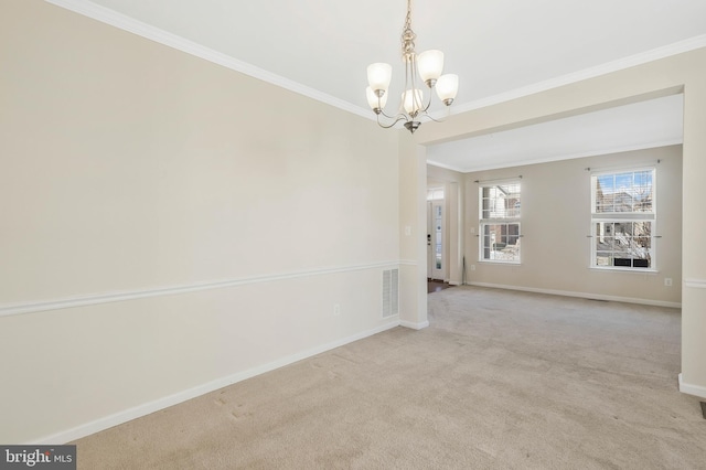 empty room with light colored carpet, ornamental molding, and a notable chandelier