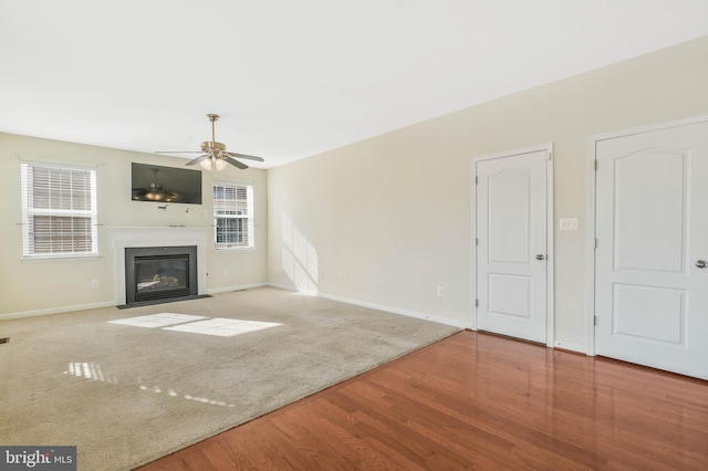 unfurnished living room with ceiling fan and light hardwood / wood-style flooring