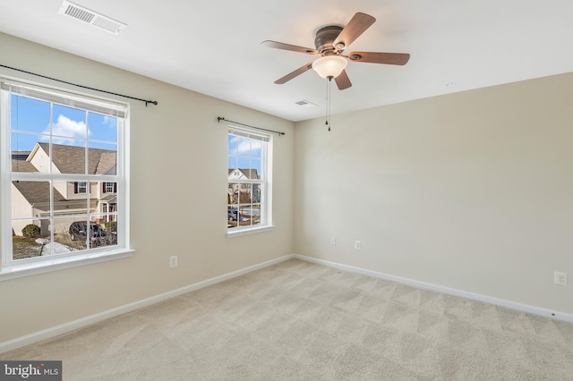 carpeted spare room with ceiling fan