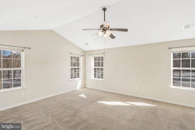 empty room with ceiling fan, lofted ceiling, and carpet floors