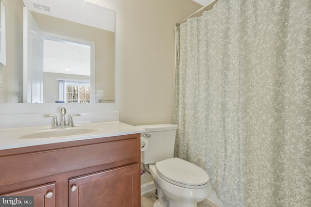 bathroom featuring vanity, tile patterned flooring, and toilet