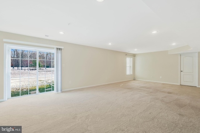 spare room featuring light colored carpet