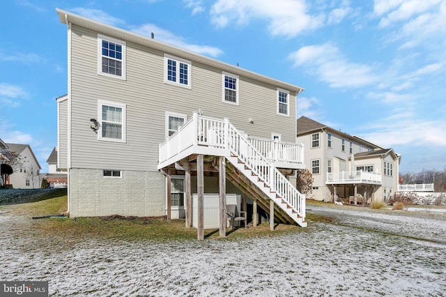 rear view of property featuring a wooden deck