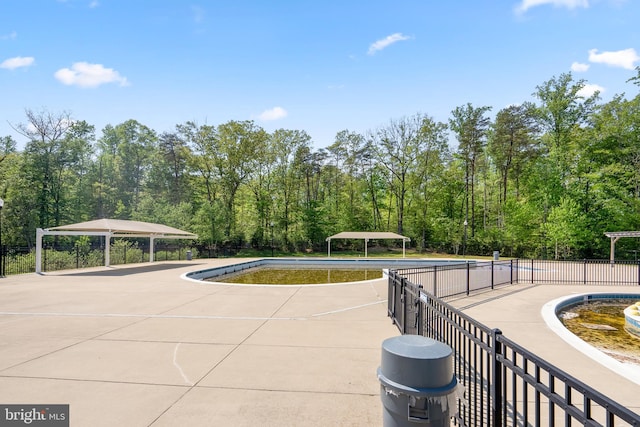 view of pool with a carport