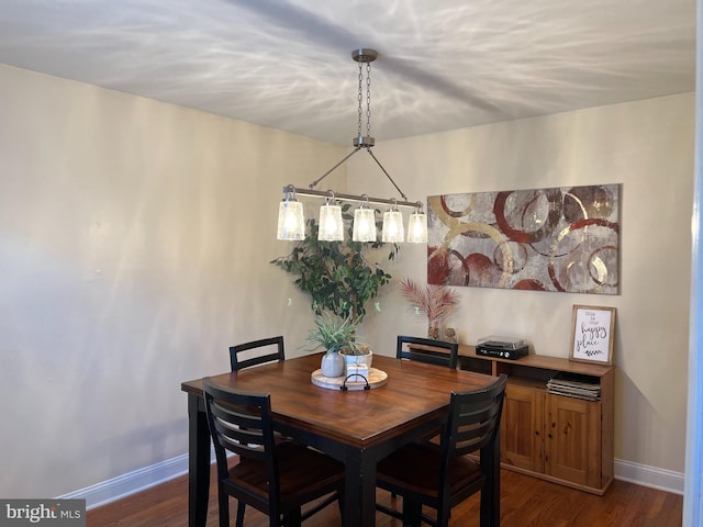 dining space with dark hardwood / wood-style floors