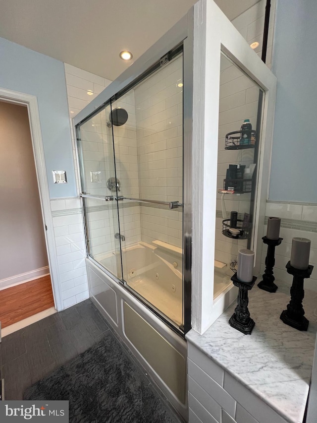 bathroom with tile patterned floors and combined bath / shower with glass door