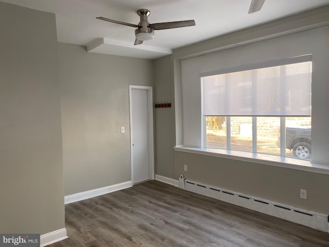 empty room with ceiling fan, hardwood / wood-style flooring, and a baseboard radiator