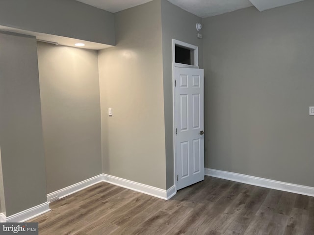 spare room with dark hardwood / wood-style flooring