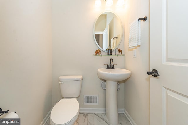 bathroom featuring toilet and sink