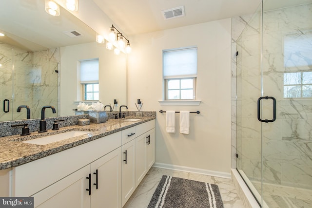 bathroom featuring an enclosed shower and vanity