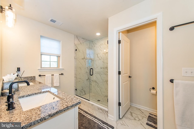 bathroom with an enclosed shower and vanity