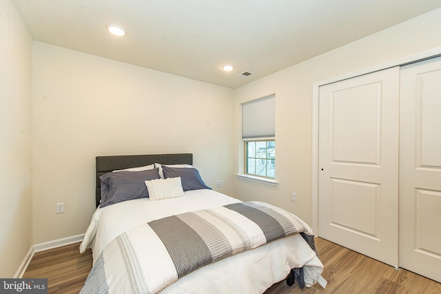 bedroom featuring light hardwood / wood-style floors and a closet