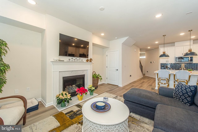 living room with a fireplace and light hardwood / wood-style floors