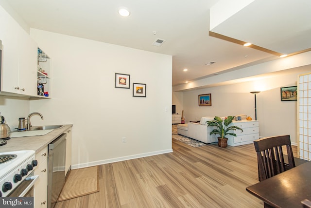 interior space with sink, white cabinetry, light wood-type flooring, stainless steel dishwasher, and electric range