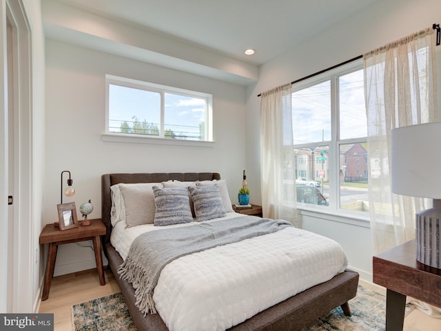 bedroom featuring light hardwood / wood-style flooring and multiple windows